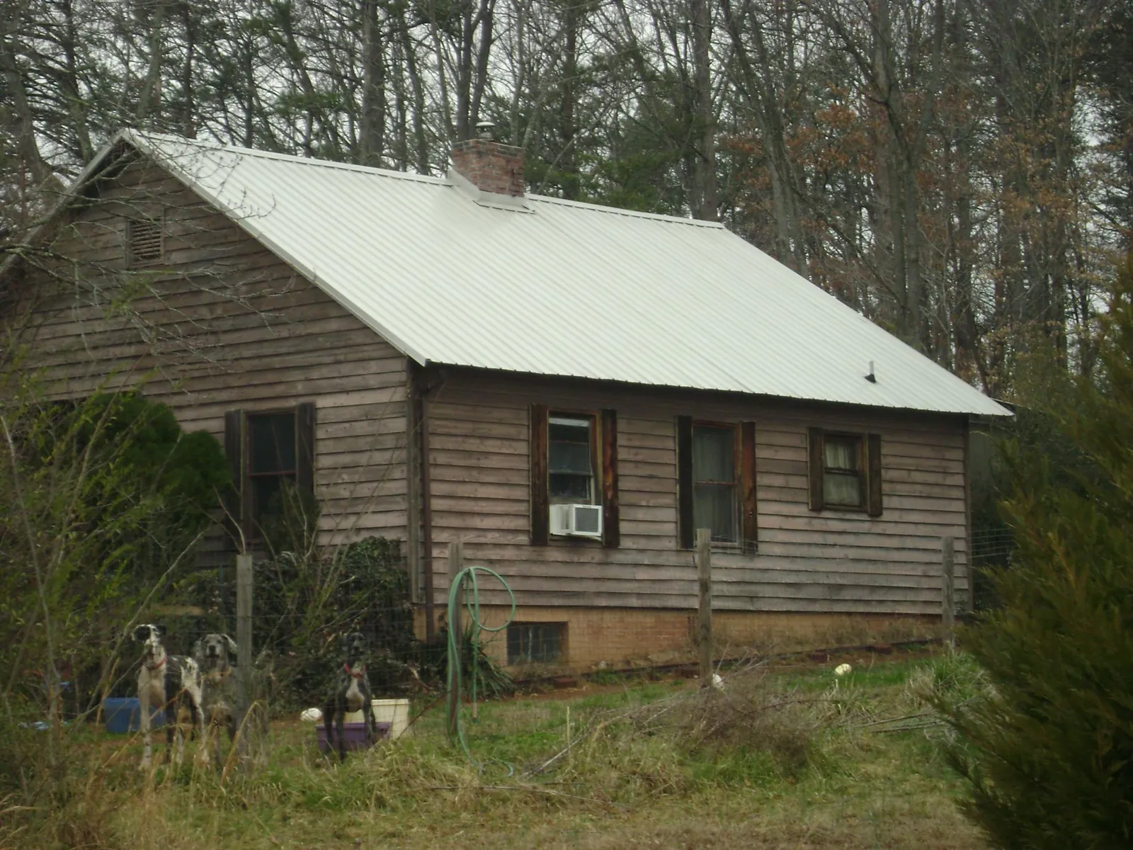 White metal roof on an old wood sided farmhouse, from a Metal Roof Installation job in Campton